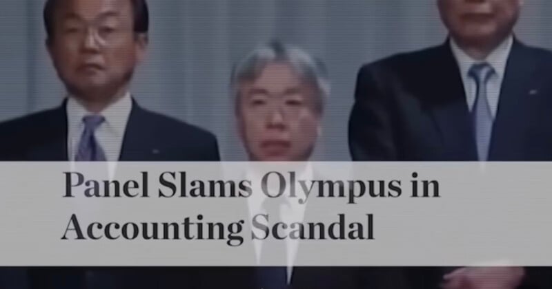 Three men in suits stand behind a headline that reads, "Panel Slams Olympus in Accounting Scandal." The image has a serious tone, suggesting a press conference or official statement.