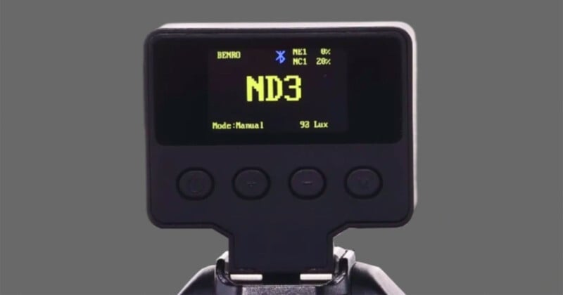 Close-up of a digital display on a camera accessory showing "ND3" in large text, with additional smaller information and four buttons below the screen, set against a plain gray background.