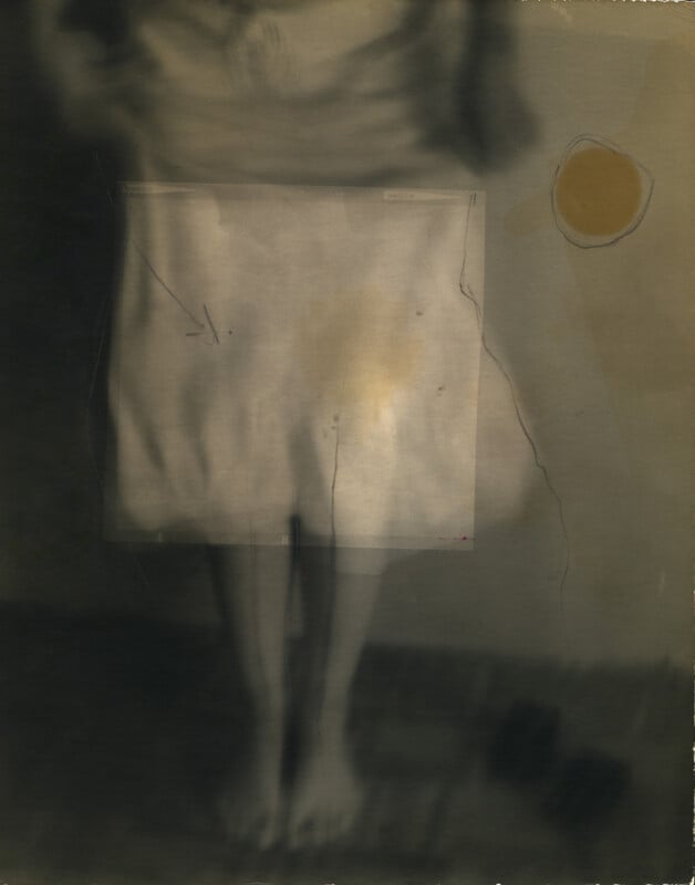 A blurred, sepia-toned image of a person standing barefoot, with their head cropped out. They wear a light skirt, partially obscured by a faded rectangular overlay. A yellowish circle appears on the right side of the image.
