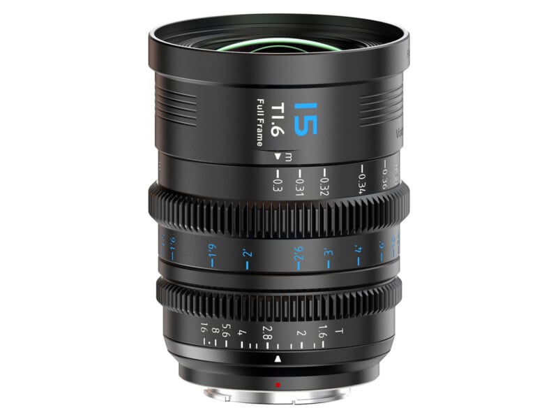 A close-up of a black camera lens with blue markings, focus and aperture rings, and white text indicating "15 T1.5 Full Frame" on the barrel. The lens is upright against a white background.