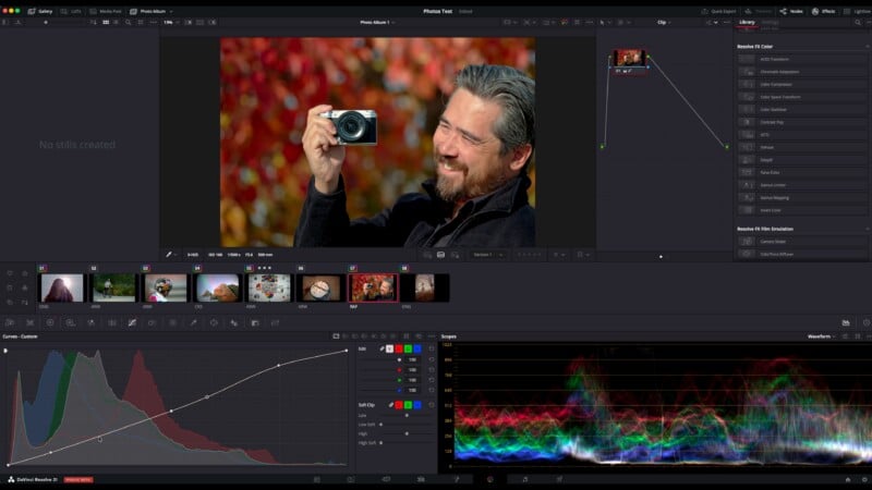A photo editing software interface shows a man with gray hair and beard smiling while holding a camera outdoors, surrounded by vibrant red foliage. Various color grading and editing tools are visible on the screen.
