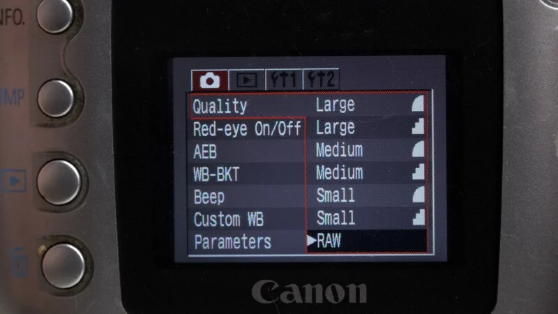 Close-up of a Canon camera screen displaying photo settings such as image quality, red-eye reduction, AEB, white balance, beep, custom white balance, and parameters set to RAW.
