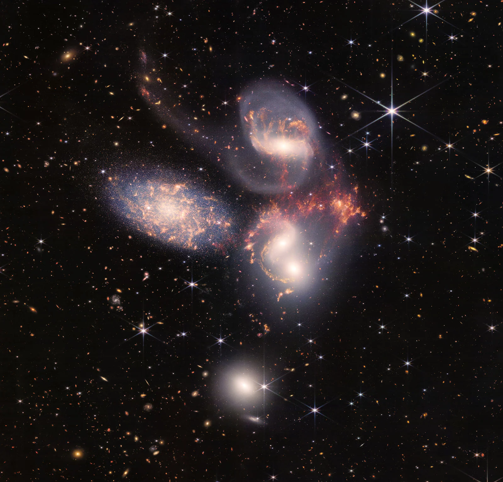 A space photo showing five large spiral galaxies against a field of smaller, more distant stars and galaxies