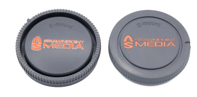 Two gray Sony E-mount camera body caps with orange "Spawnpoint Media" branding, shown from the front and back.