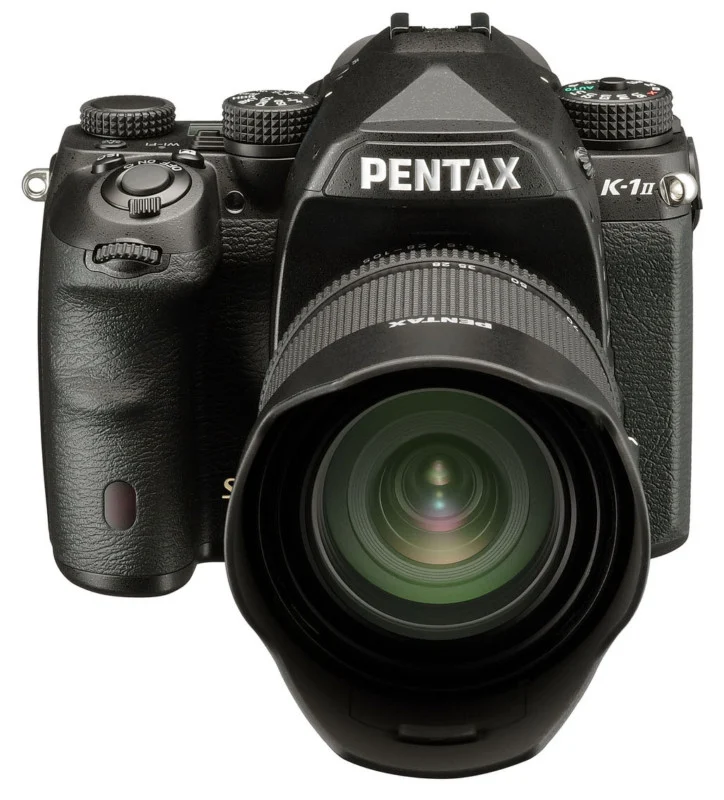 A black Pentax K-1 Mark II DSLR camera with a lens attached, viewed from the front against a white background.