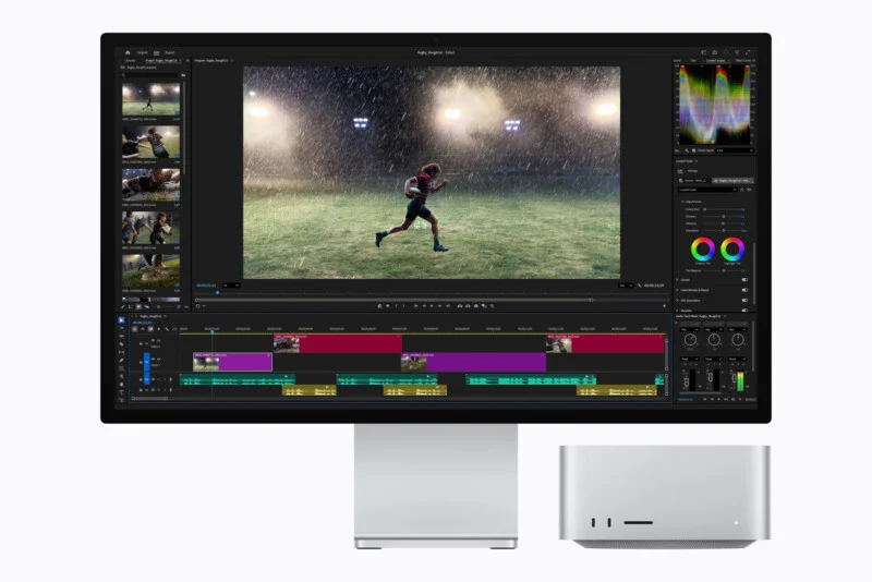 A computer monitor displaying video editing software with a rugby player on screen, positioned next to a silver desktop computer tower.