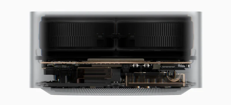 A cross-section view of a computer showing internal cooling fans, a circuit board, and metal heat sinks inside a cylindrical housing.