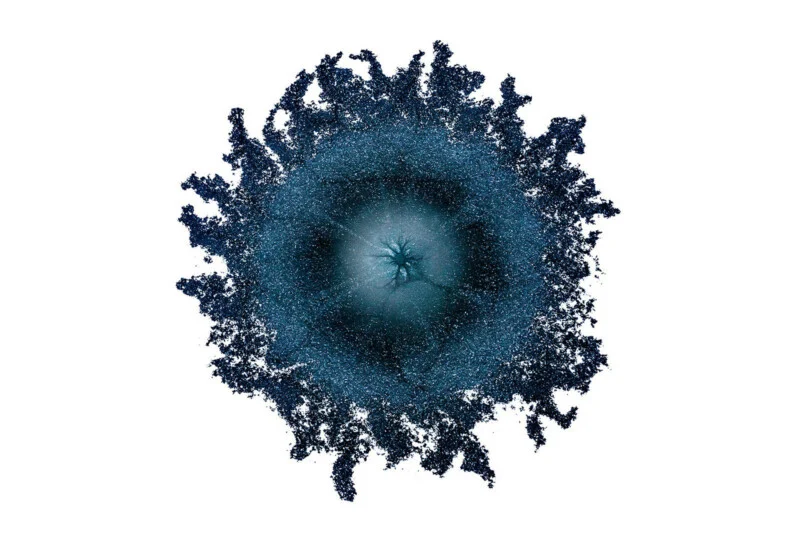 A circular, dark blue textured shape with a lighter, star-shaped center and irregular, frayed edges against a white background.