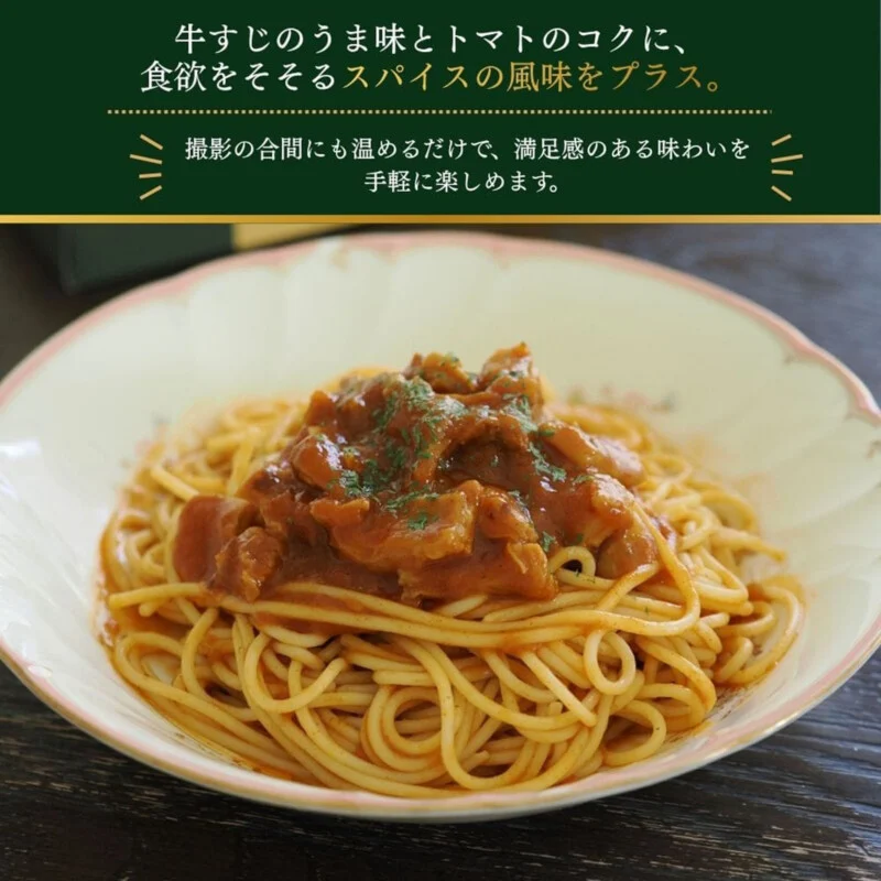A plate of spaghetti topped with a beef tendon and tomato-based sauce, garnished with herbs, set against a dark background with Japanese text above.