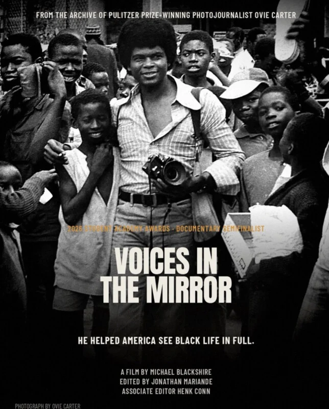 A black-and-white film poster for "Voices in the Mirror" features a smiling man with an afro holding a camera, surrounded by a crowd of children.