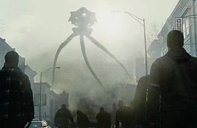 A group of people stand in a street looking toward a large, three-legged alien machine emerging from thick fog.