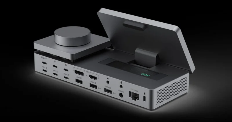 A gray, multi-port docking station with a circular dial on the left, an open storage compartment labeled "SSD" on the right, and various USB, display, audio, and network ports along the back.