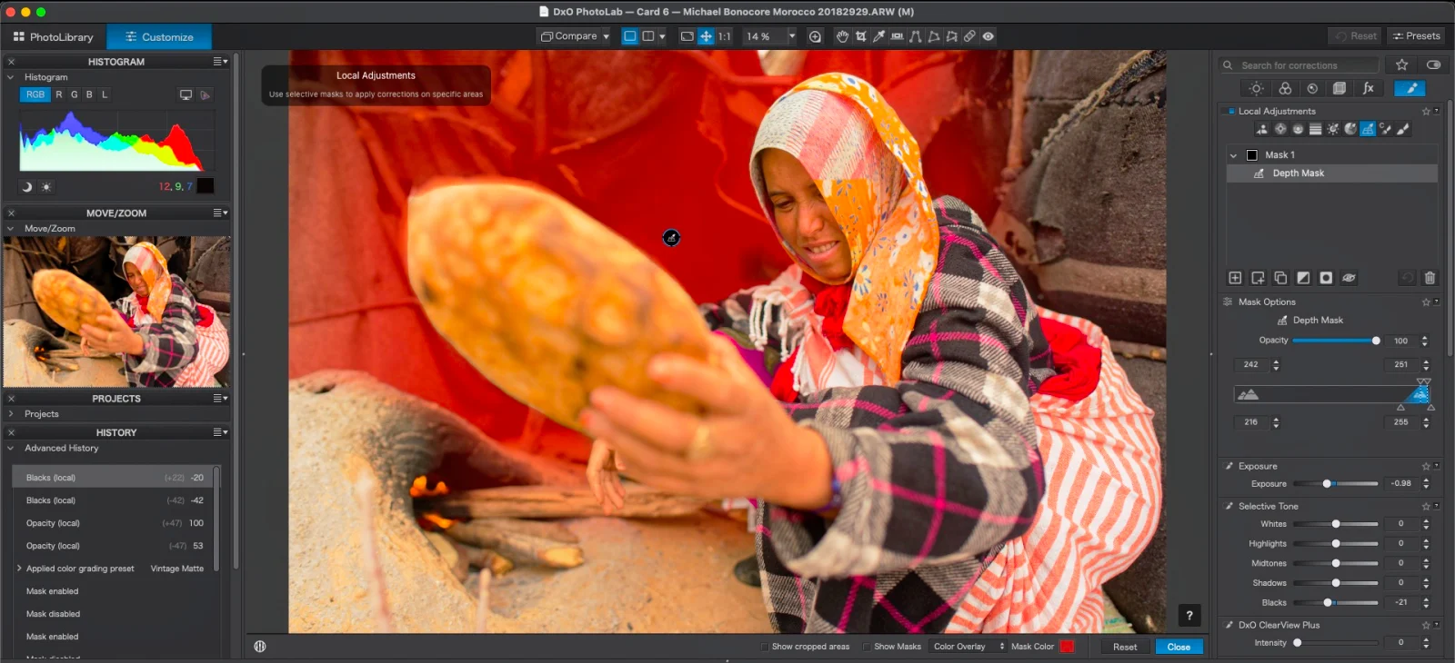 A computer screen displays the DxO PhotoLab software interface with a photo of a woman holding a flatbread in front of a fire, showing an active red depth mask overlay.