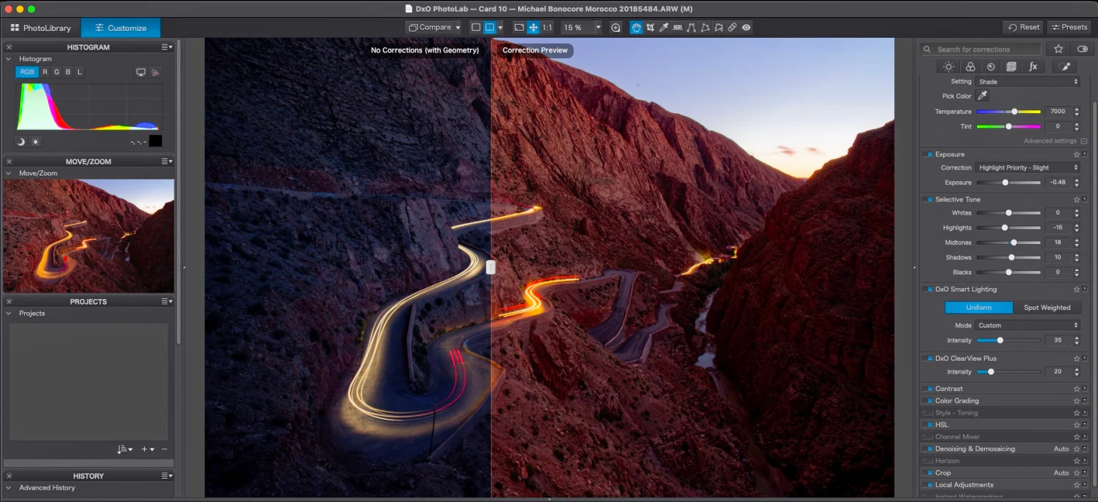 A computer screen displays the DxO PhotoLab software interface, showing a winding road through a canyon with a red mask overlay applied to the mountainside.