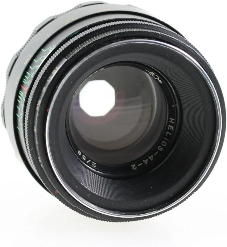 A black Helios-44-2 2/58 camera lens viewed from the front, showing the glass elements and aperture blades.