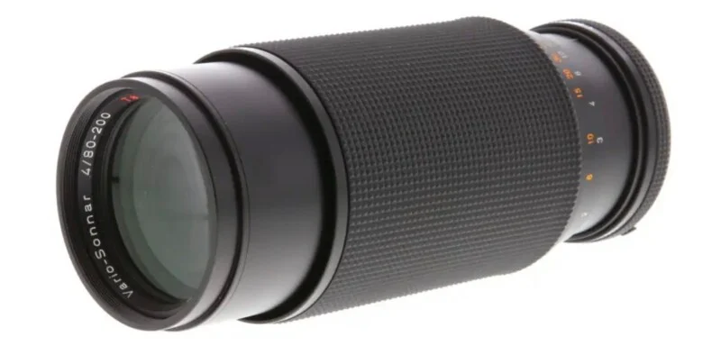 A black Vario-Sonnar 4/80-200 camera lens positioned at an angle against a white background.
