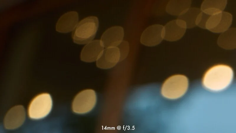 Out-of-focus, oval-shaped golden light orbs are scattered against a dark, blurry background, with the text