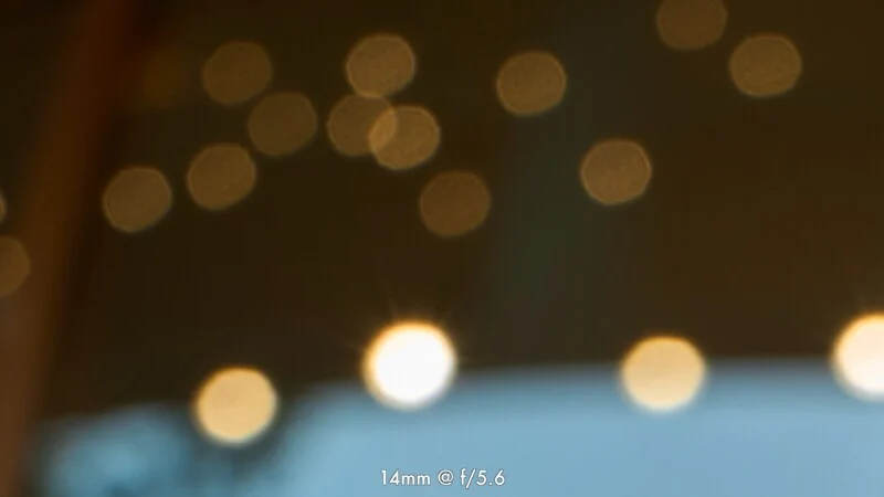 A collection of out-of-focus, circular golden light orbs against a dark background, with text at the bottom reading