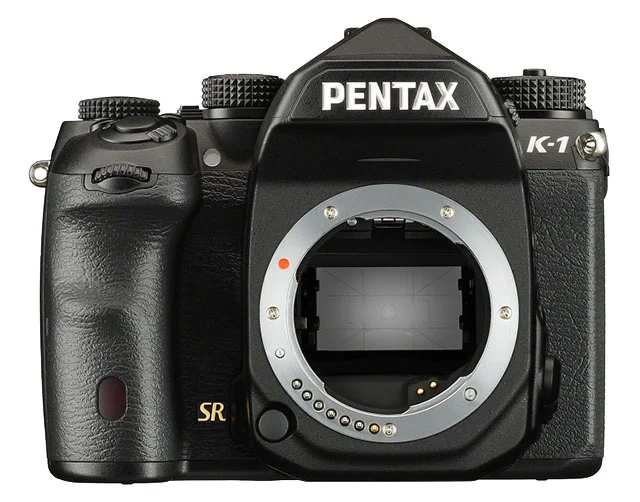 A front view of a black Pentax K-1 digital SLR camera body with the lens removed, showing the sensor and lens mount.