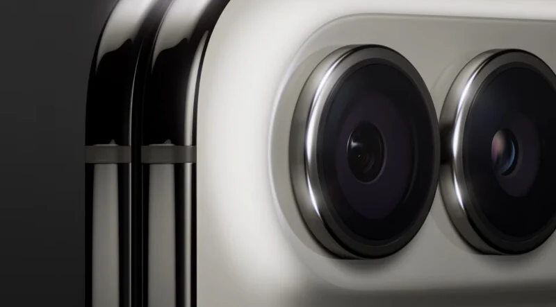 A close-up view of two circular camera lenses set into a metallic, light-colored housing on the back of a smartphone.