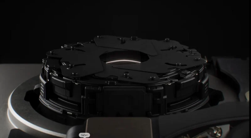 A close-up view of a mechanical camera aperture mechanism with overlapping black blades surrounding a central lens opening.