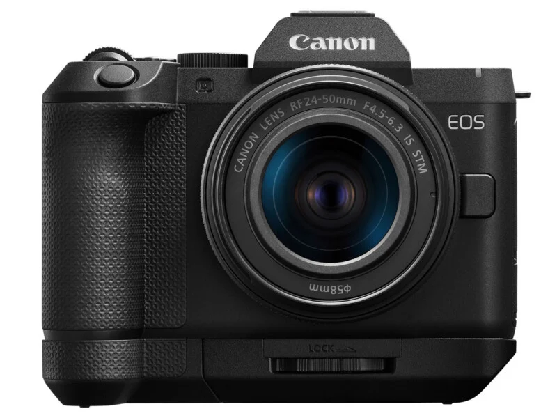 A front-facing Canon EOS mirrorless camera with an attached RF 24-50mm lens and a battery grip.