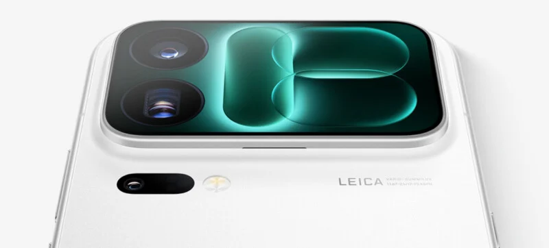 A close-up of the back of a white smartphone featuring a large, rectangular camera module with two lenses and a glowing green abstract design, along with a smaller secondary lens, a flash, and the text "LEICA VARIO-SUMMILUX 1:1.67-2.4/17-75 ASPH.