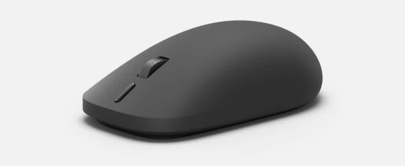 A matte black wireless computer mouse with a scroll wheel and two buttons, viewed from a high angle against a white background.
