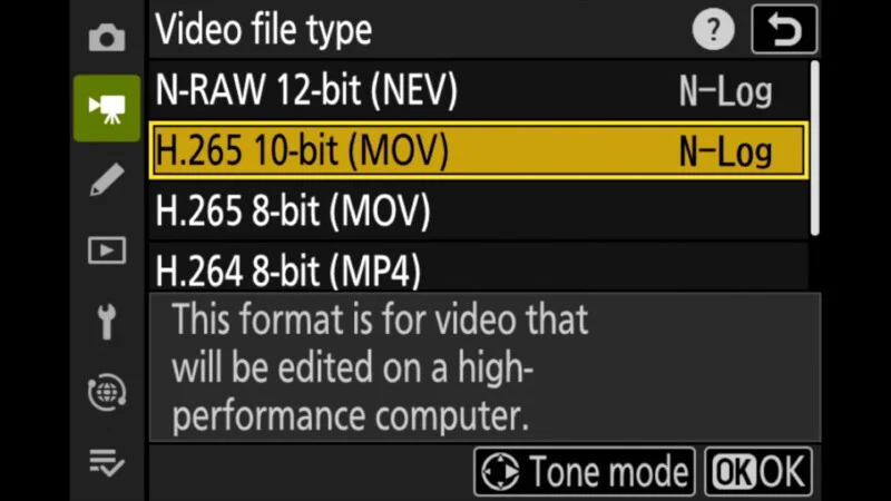 A camera menu screen displaying video file type options, with H.265 10-bit (MOV) highlighted and a description box below.