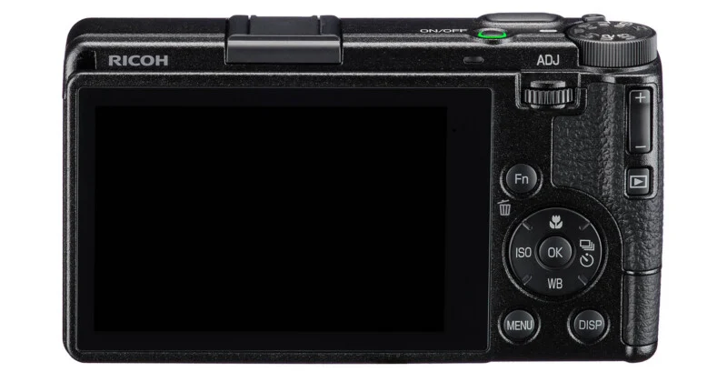 The back of a black Ricoh digital camera featuring a large LCD screen, a mode dial, an ADJ dial, and various control buttons including Fn, Menu, Disp, and a directional pad with an OK button.