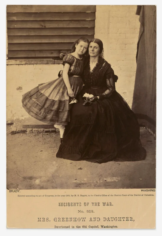 A sepia-toned portrait of Rose O'Neal Greenhow and her daughter, Rose, sitting together in the Old Capitol Prison in 1862.