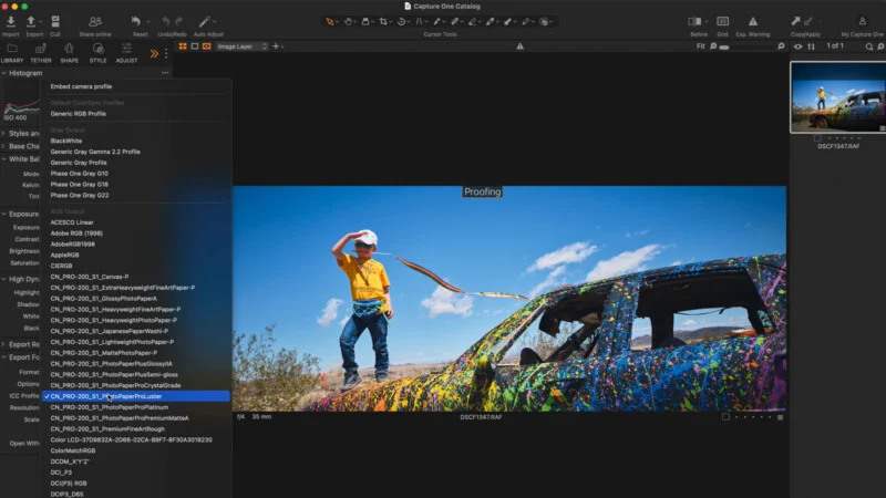A Capture One software interface displays a color profile selection menu over a photograph of a child standing on a painted car.